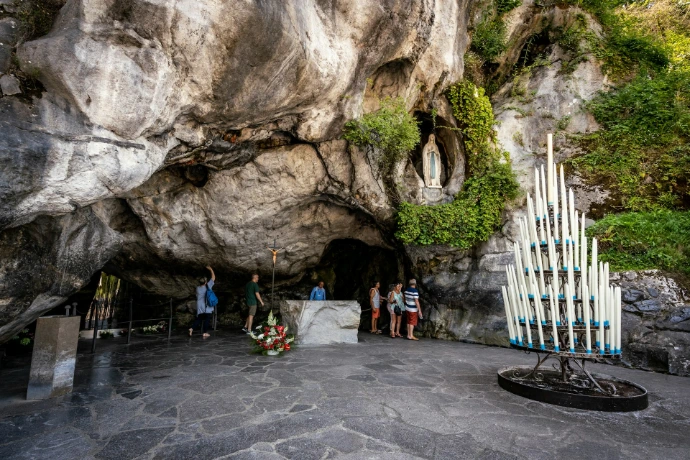 a group of people standing inside of a cave